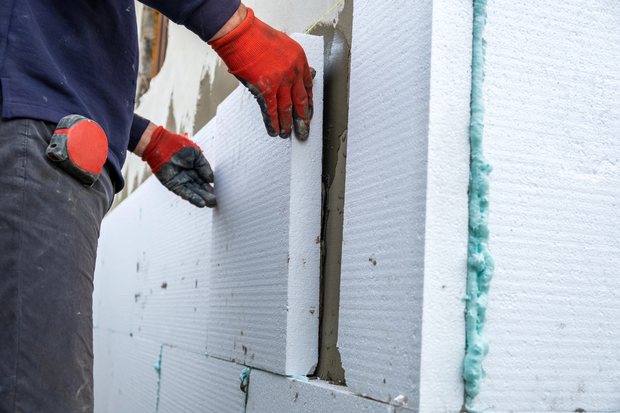 construction-worker-installing-styrofoam-insulation-sheets-house-facade-wall-thermal-protection
